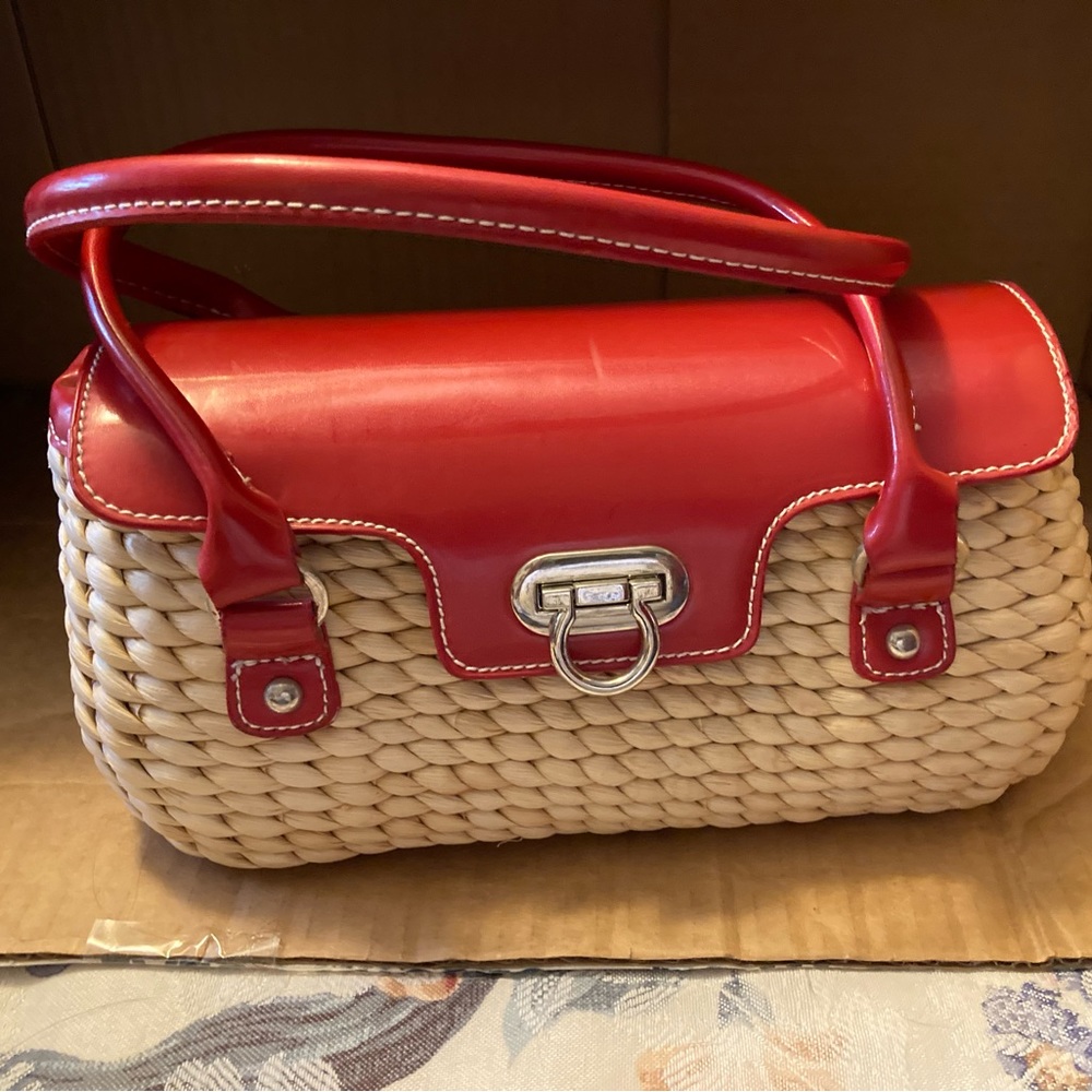 Pocketbook red top with closure and beige wicker bottom.
